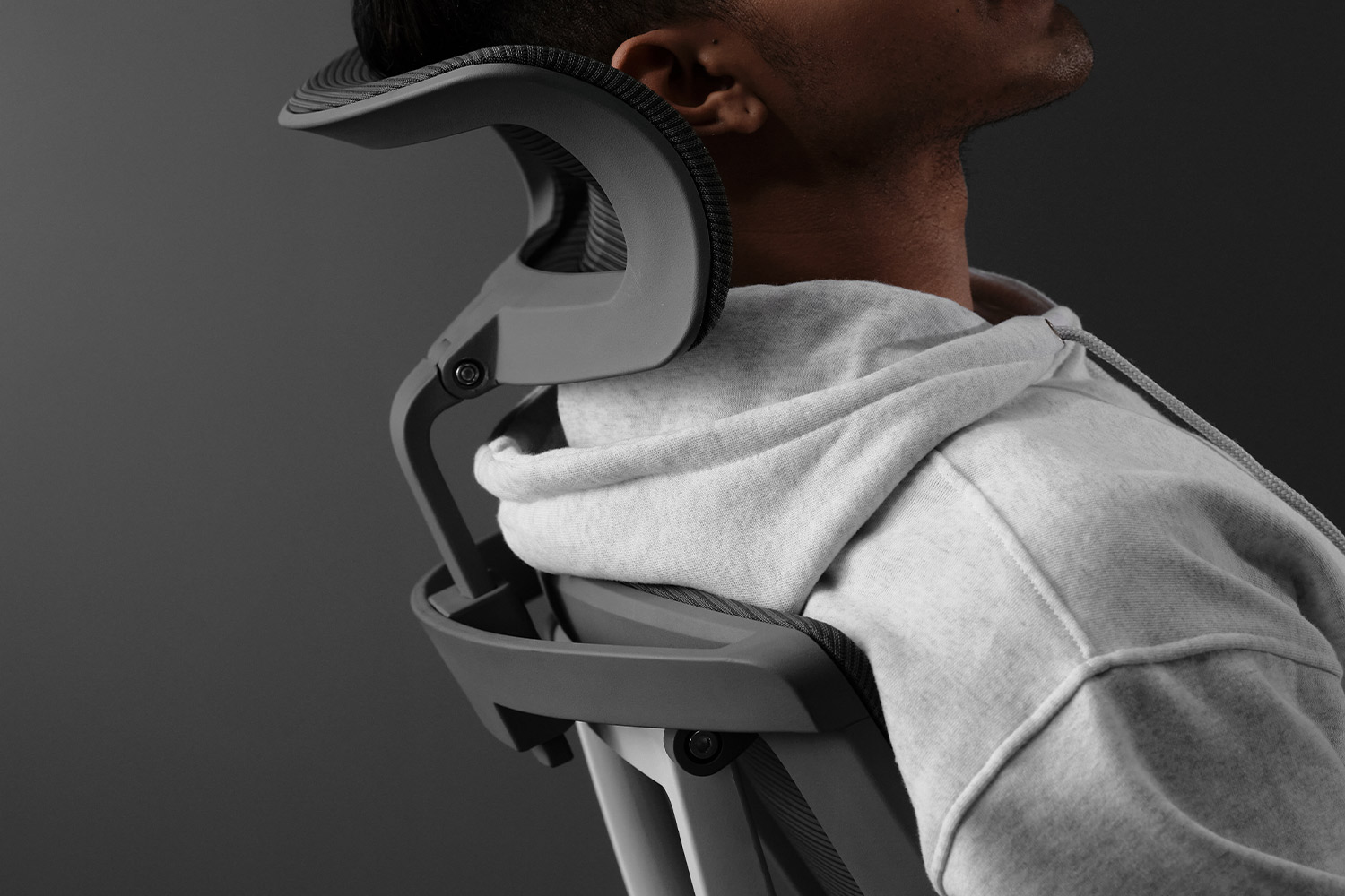 An ergonomic chair with a headrest assists at work by reducing muscle tension