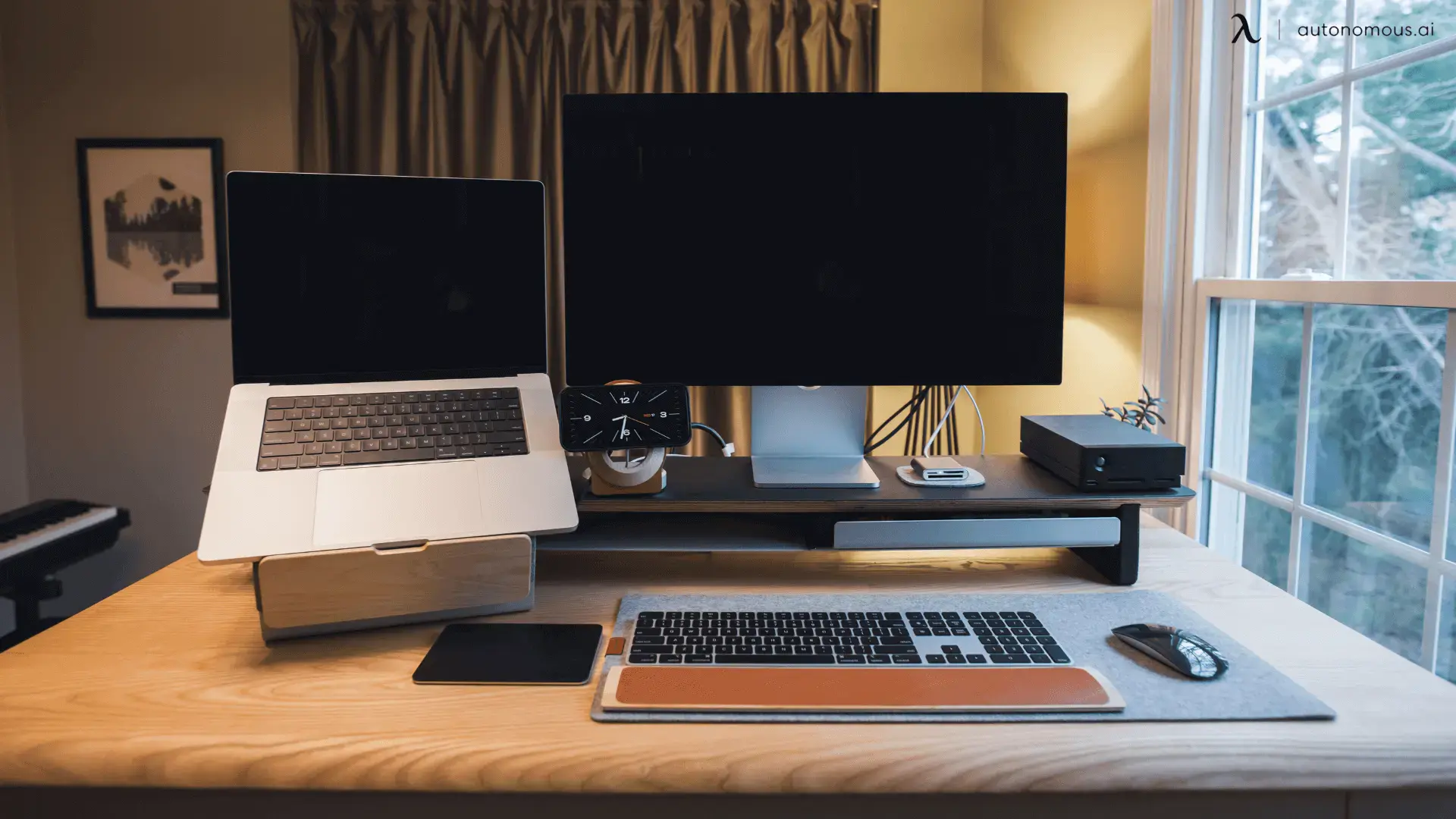 Laptop stand and single monitor on light wood