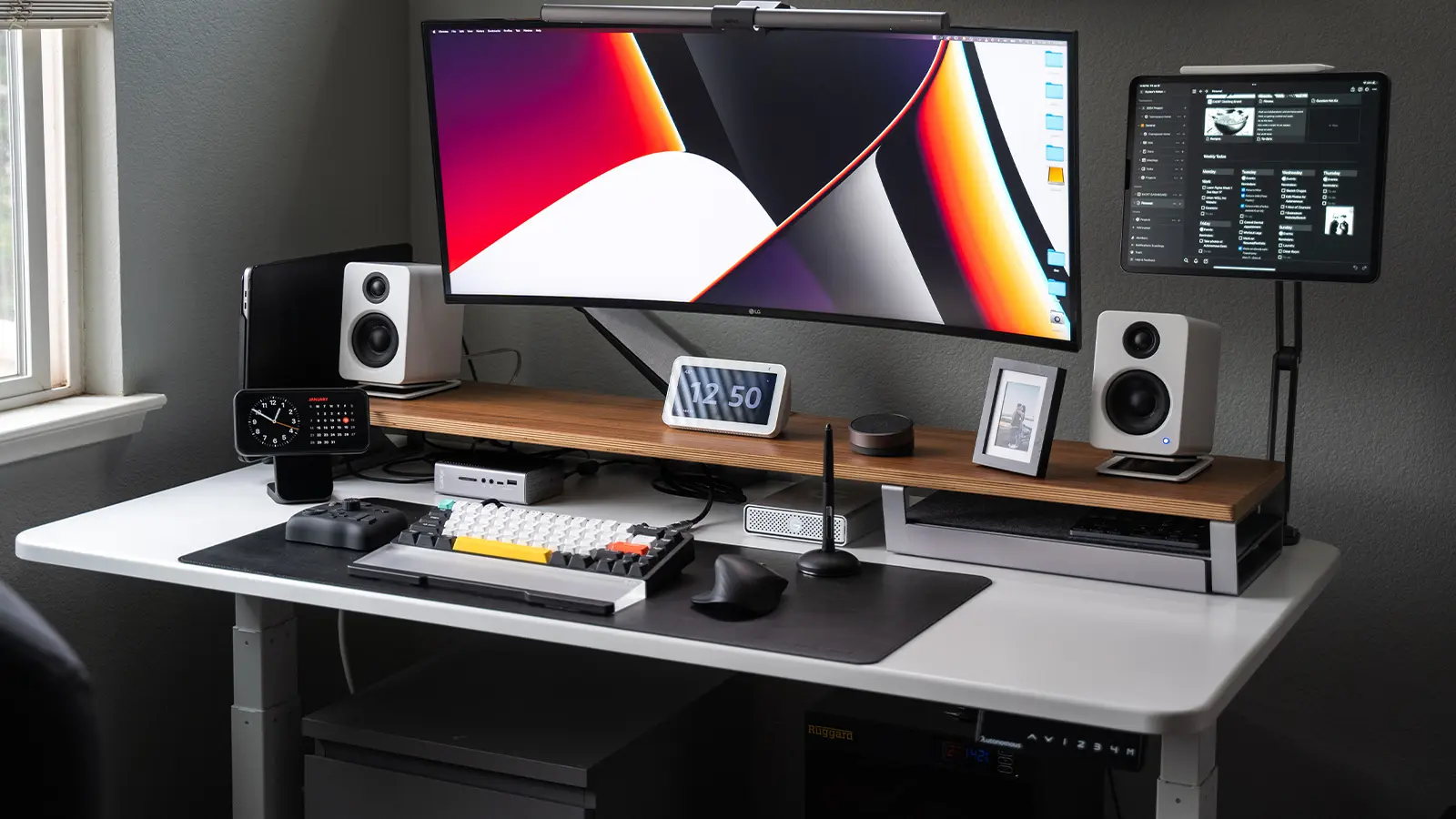 black and white gaming setup with white desk against a dark wall