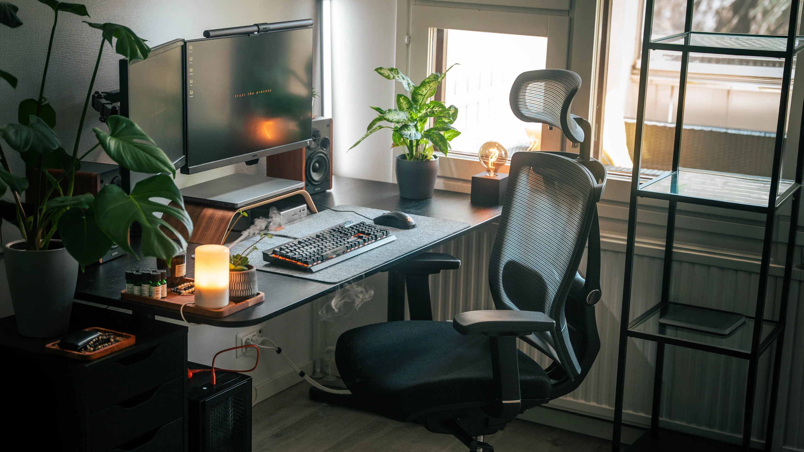 Person working at a multi-monitor desk in the ErgoChair Pro
