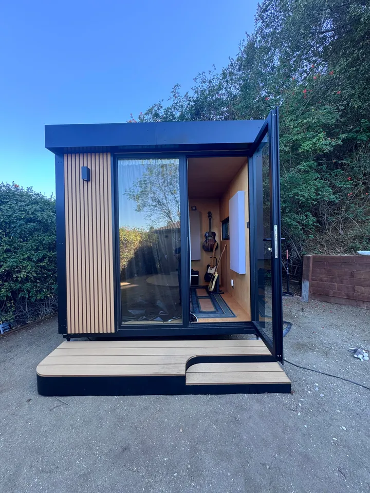 Black WorkPod with wood slat panels and an entry deck