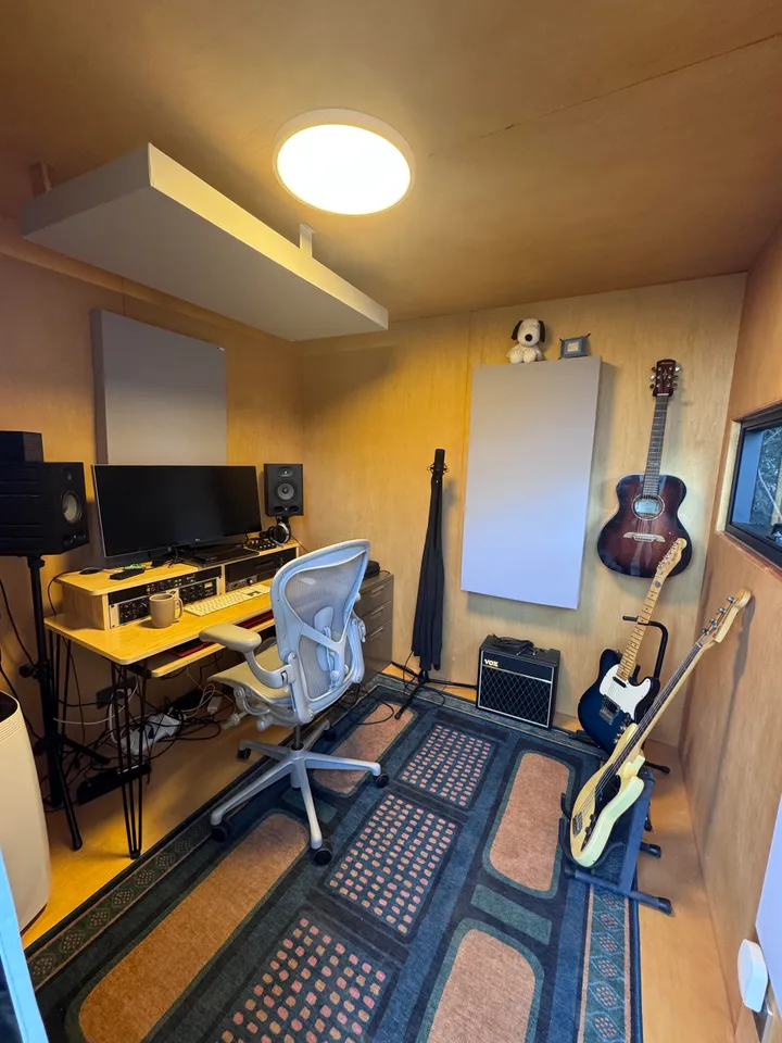 Music studio with guitars and a desk inside a WorkPod