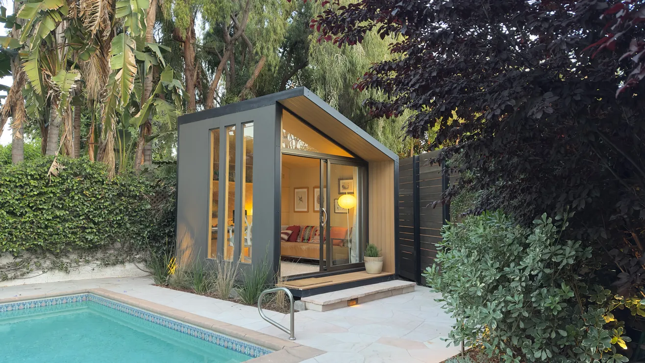WorkPod beside a backyard swimming pool