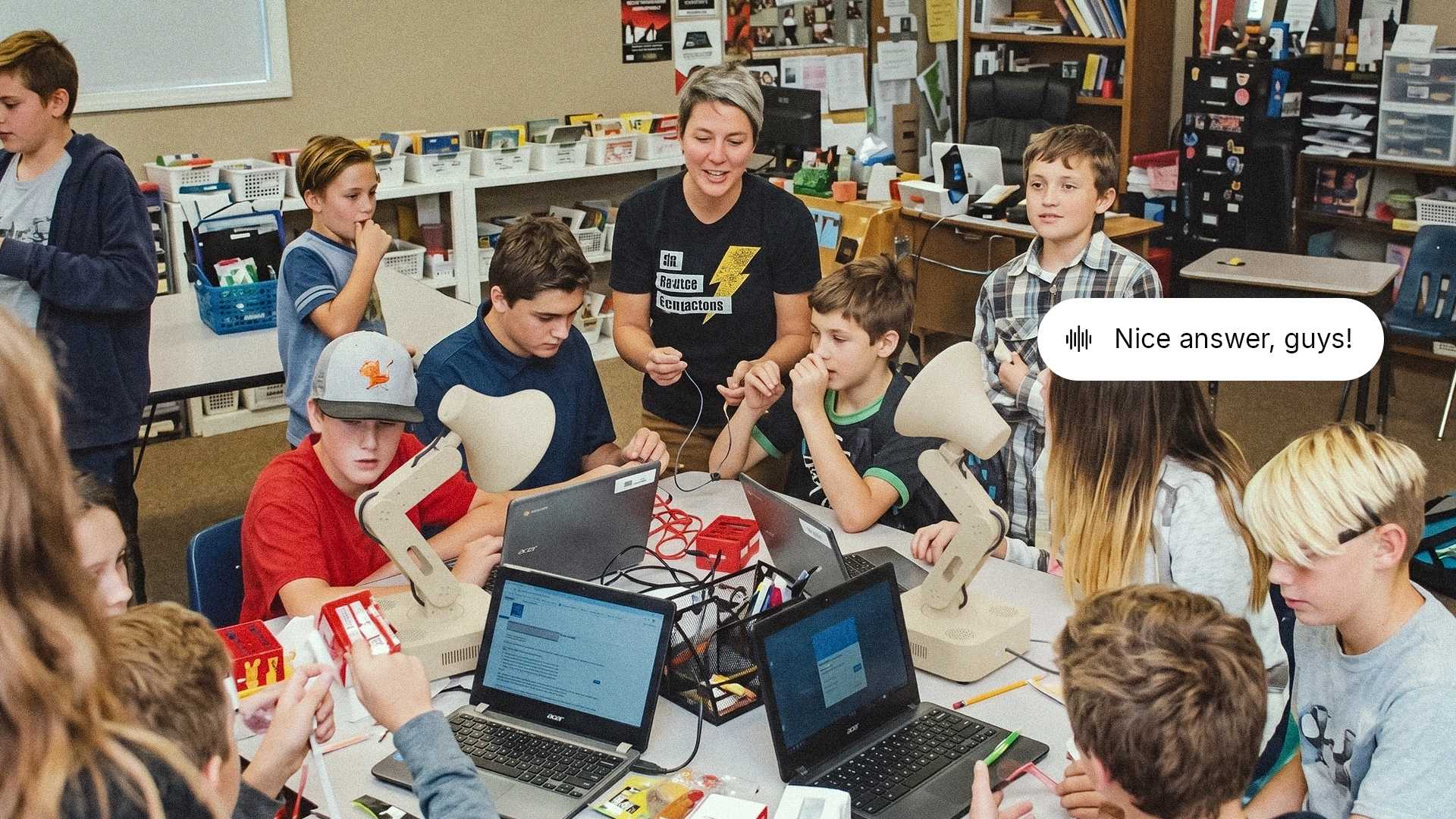 Concept of a teacher and students programming Lamps on laptops in a classroom