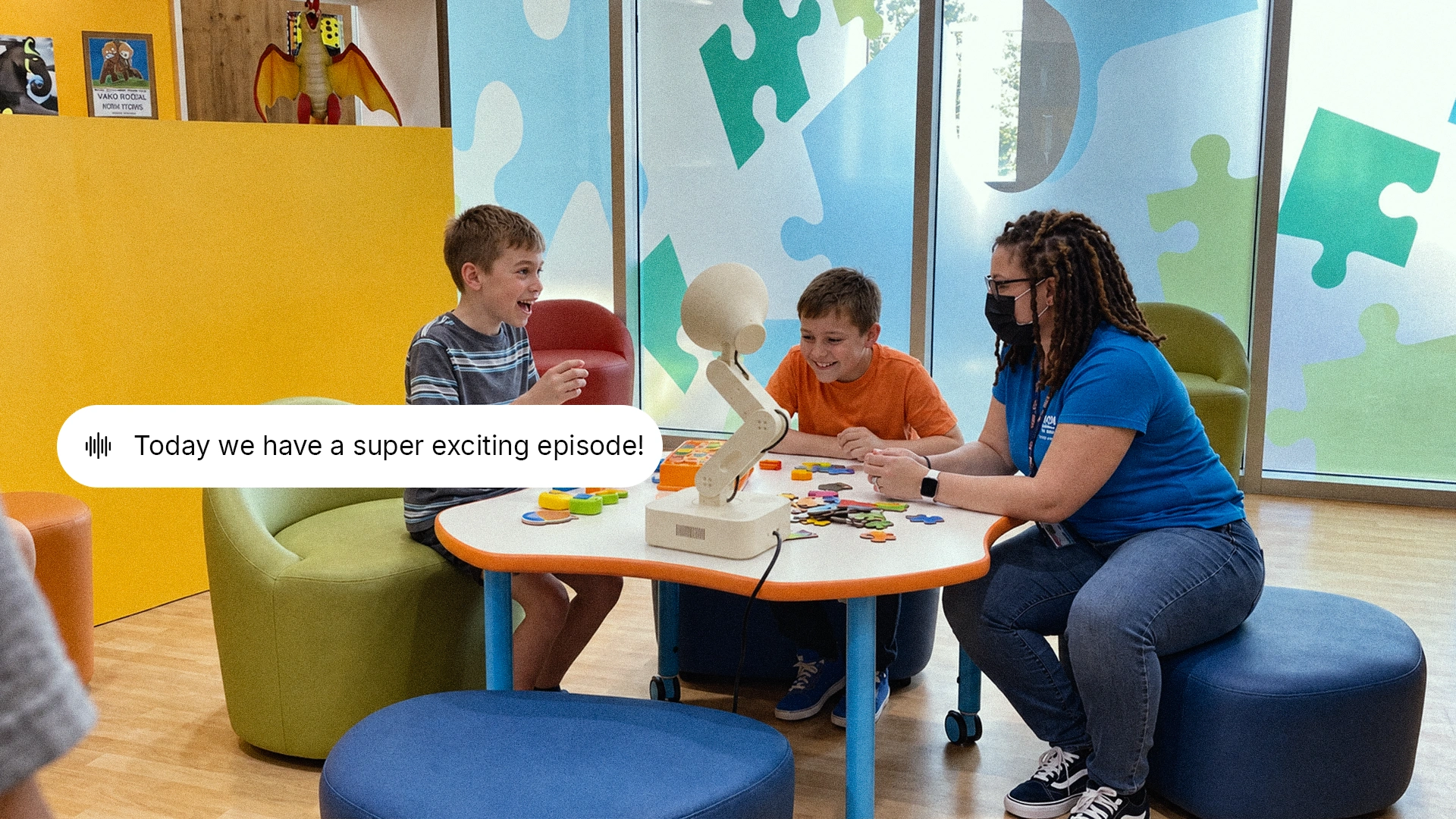 Concept of children and an adult around a table as Lamp starts a story
