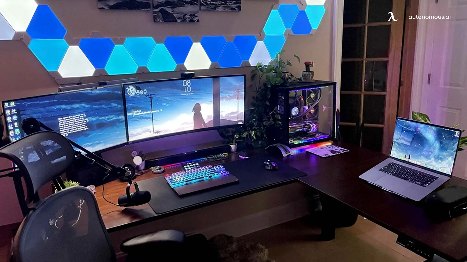 L-shaped RGB desk setup with multiple screens and a computer tower