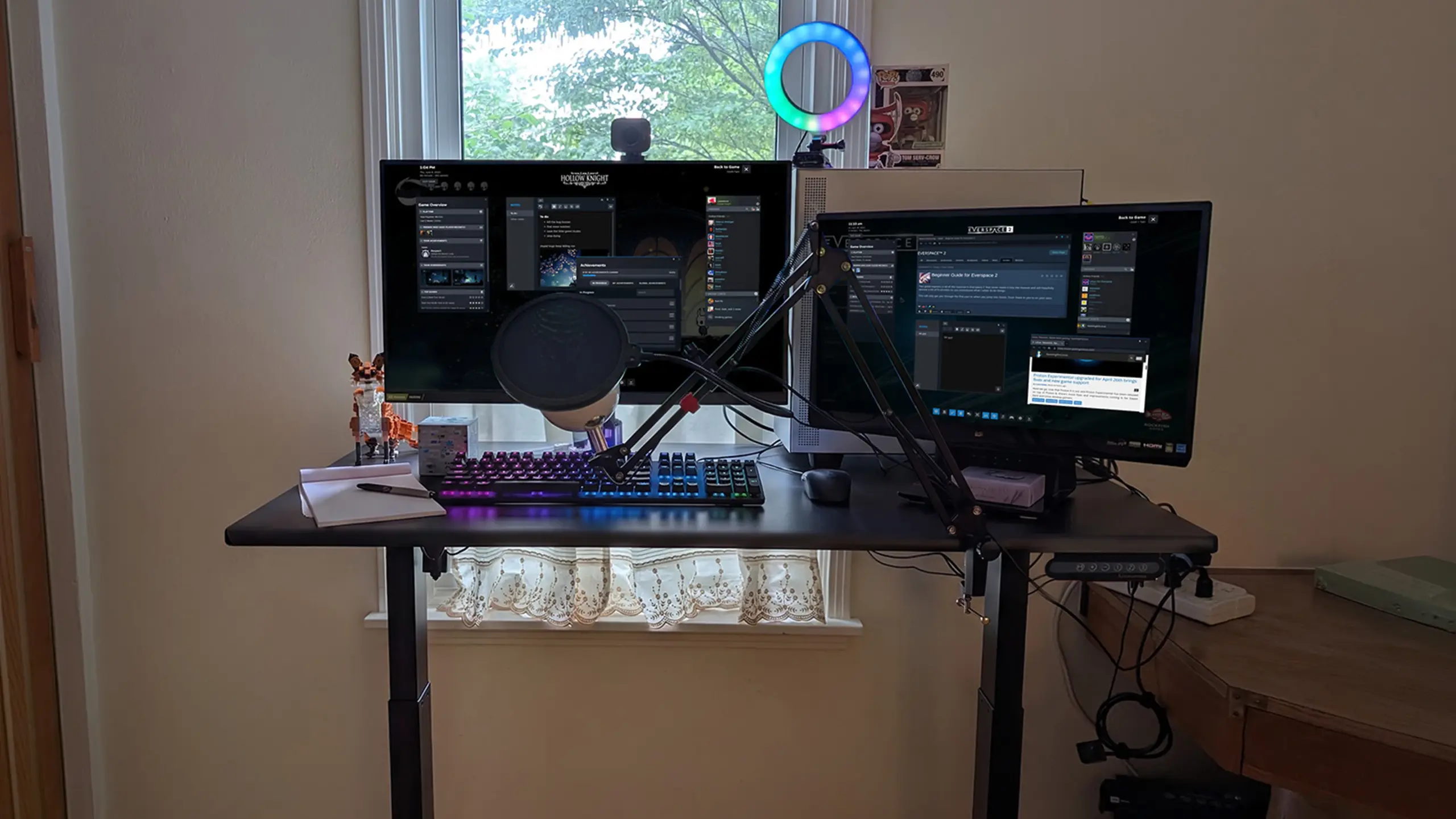 Dark workstation with monitors, PC equipment and compact desk arrangement
