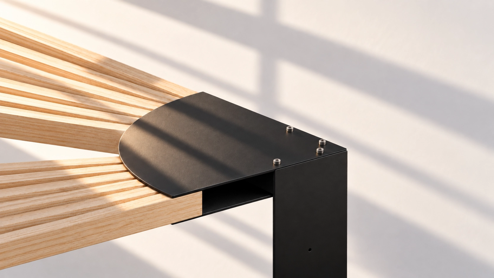 Close-up of the black steel hub at the top of the column, with wood arms fixed by black brackets